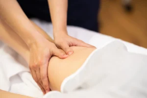 Blog 2 medical massage at the leg in a physiotherapy cent H76QKD8 scaled 1